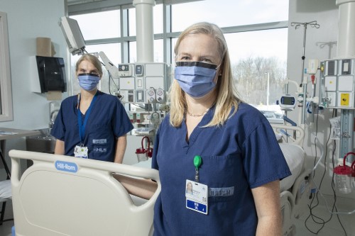 Irene Watpool and Rebecca Porteous standing near an empty bed in the ICU